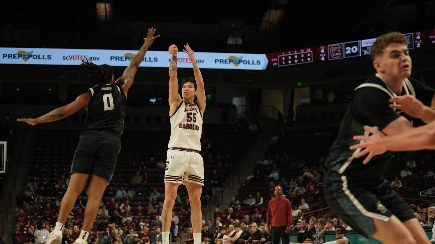 South Carolina pushes offense as senior guard Mike Sharavjamts elevates for a jumper while Stetson defenders scramble to close out. The scene occurred inside Colonial Life Arena in Columbia, South Carolina.