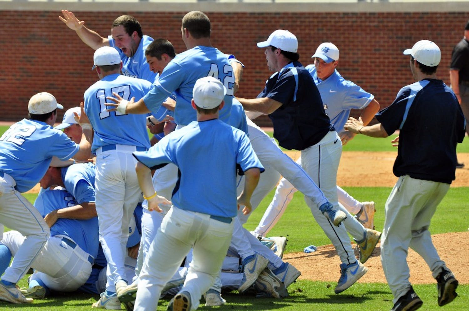 UNC players celebrate in a dog pile after the game.