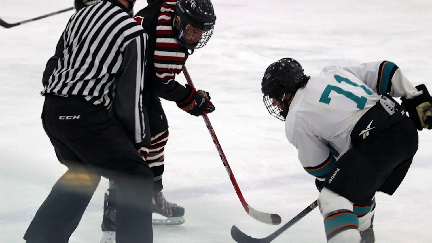 Jacob Tengi (black) takes on Brett Sireikis (71) in a puck drop.