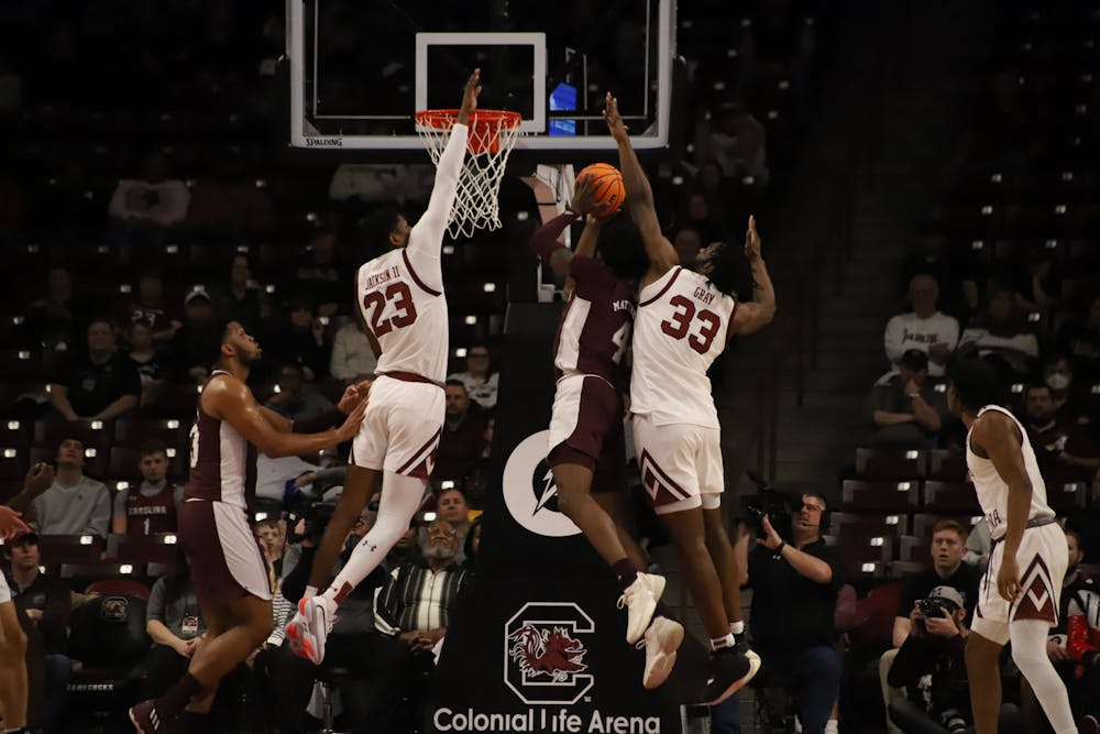 <p>Freshman forward Gregory “GG” Jackson II and junior forward Josh Gray soar through the air to try to block Mississippi State's shot on the basket. This game was held in the Colonial Life Arena on Jan. 31, 2023. The South Carolina Gamecocks lost 66-51.</p>