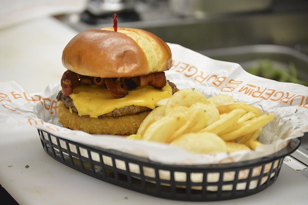 <p>Burger IM’s Angus Beef Burger Cowboy Style features the additions of bacon, an onion ring, and barbecue sauce. The Columbia burger restaurant is the newest franchise in the chain.</p>