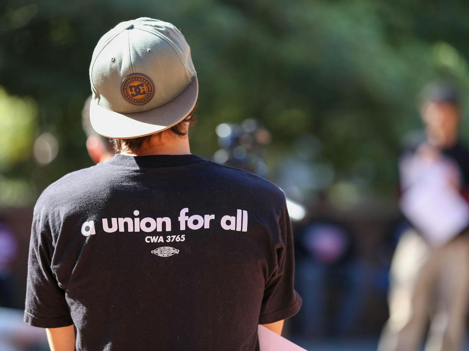 A member of United Campus Workers observes from the crowd during a USC worker speak-out event held on the Russell House Patio on Oct. 26, 2023. The event was hosted by the United Campus Workers union at USC.