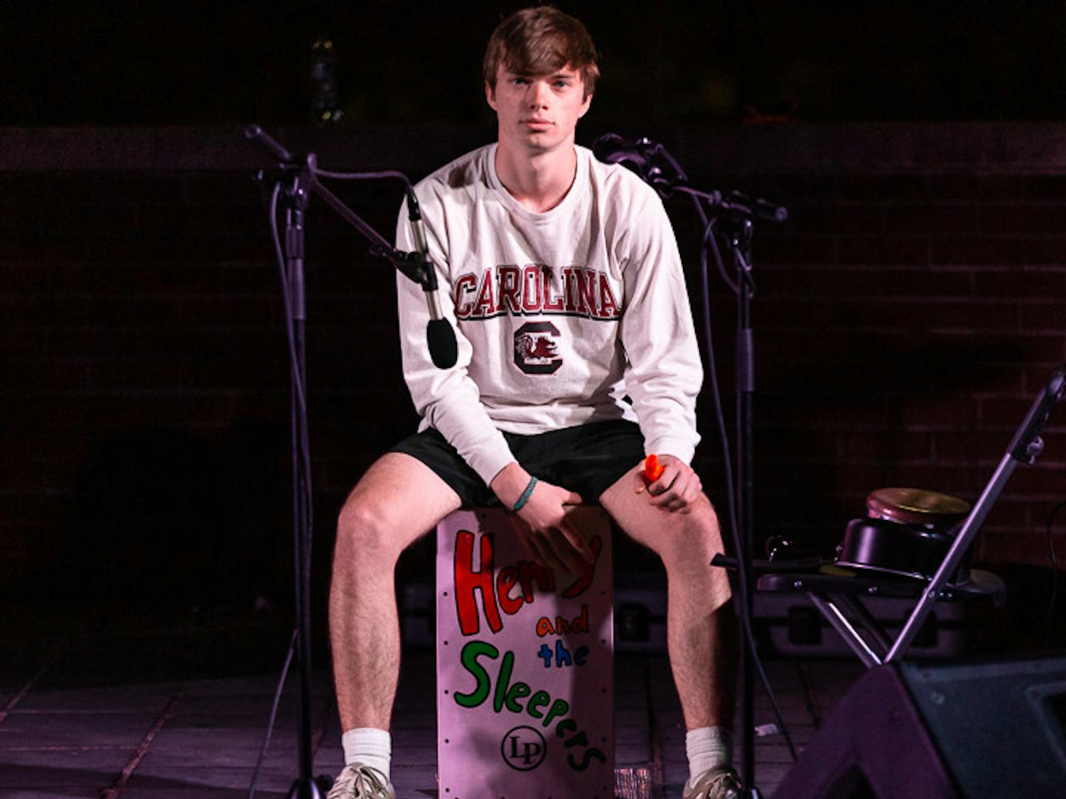 Second-year operations and supply chain student Sean Wright, the cajon drummer for Henry and the Sleepers, keeps the tempo during the band's set at the Battle of the Bands on Oct. 5, 2022. The competition brought acappella, folk, rap and rock to the Russel House Patio in a variety of performances. 