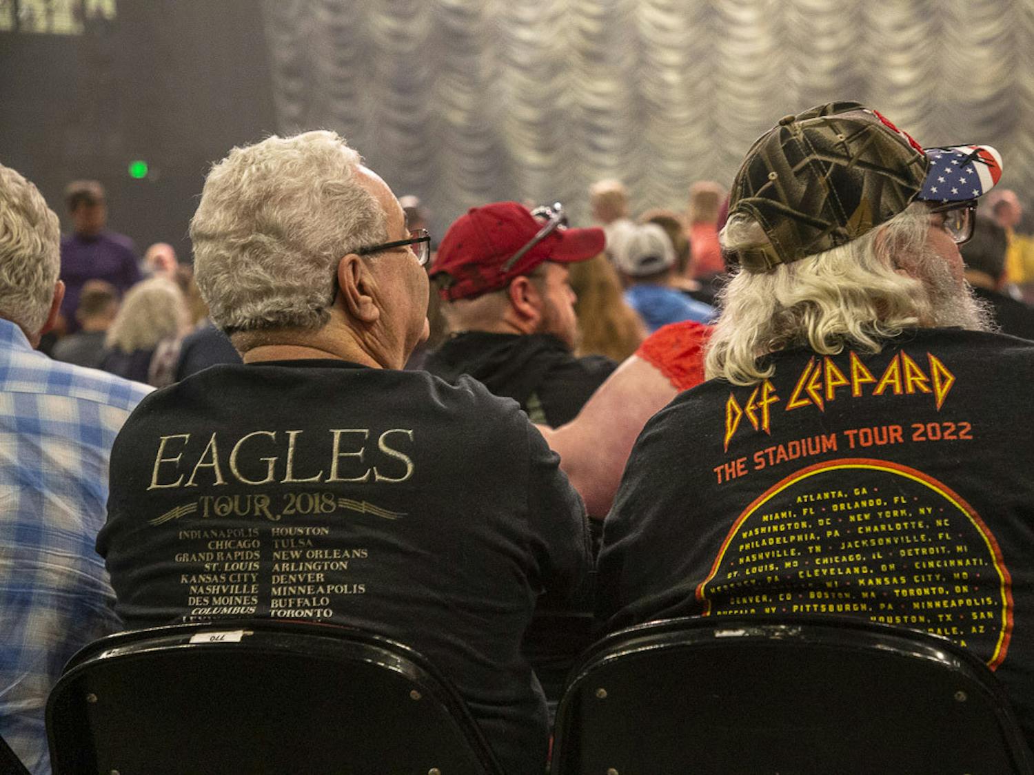 A couple with Eagles and Def Leppard band tees sit among the many fans in attendance for the Eagles concert at Colonial Life Arena on March 30, 2023. Fans of all ages attended the event, and the band performed songs from its "Hotel California" album as well as some of its greatest hits.