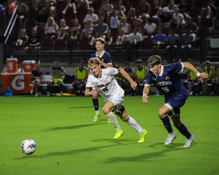Freshman Midfielder Christiano Bruletti (on left) races Queens graduate student Caleb Patsch (on right) for the ball during the Gamecocks' match against the Royals on Sept. 20, 2022. South Carolina beat Queens 3-1.
