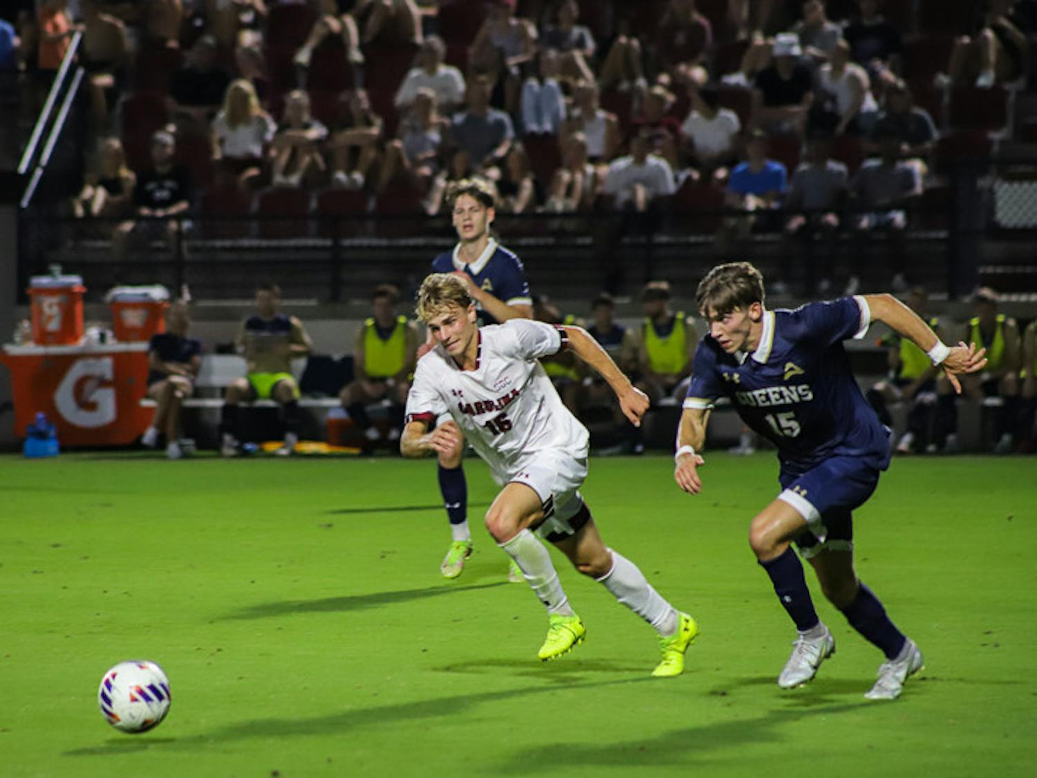 Freshman Midfielder Christiano Bruletti (on left) races Queens graduate student Caleb Patsch (on right) for the ball during the Gamecocks' match against the Royals on Sept. 20, 2022. South Carolina beat Queens 3-1.