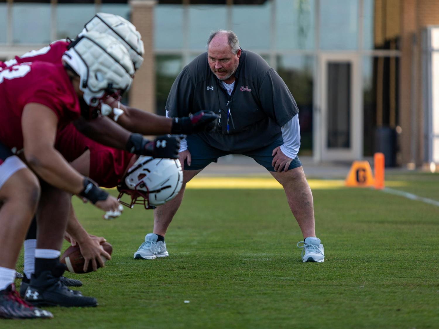 FILE— Offensive Line coach Greg Adkins coaches players during a spring practice in 2021. 