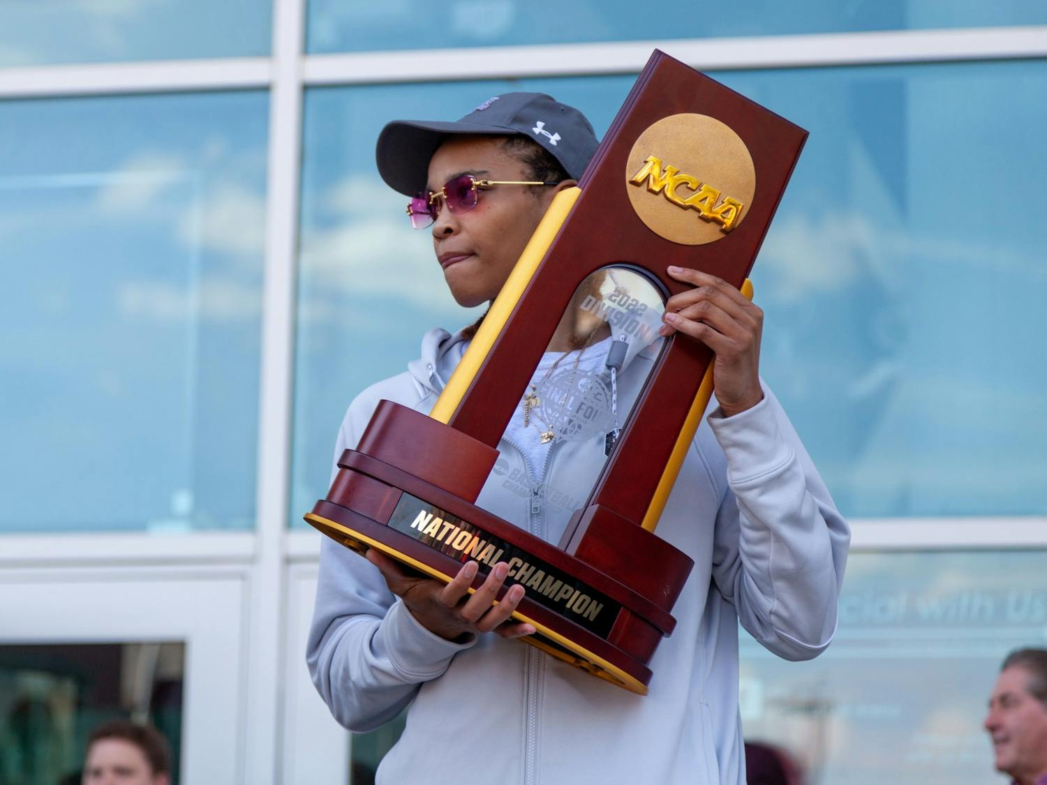 South Carolina graduate guard Lele Grissett walks onto the stage with the NCAA championship trophy on April 4, 2022 at Colonial Life Arena in Columbia, SC. Many fans gathered outside of the arena for the team's return to Columbia.