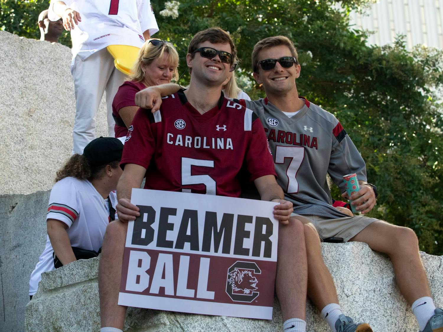 USC students Gavin Howley (left) and Thomas Gribben (right) holding a "Beamer Ball" sign at Romare Bearden Park ahead of College GameDay on Sept. 2, 2023. Howley and Gribben traveled to Charlotte to support the Gamecocks ahead of the Duke's Mayo Classic later in the day.