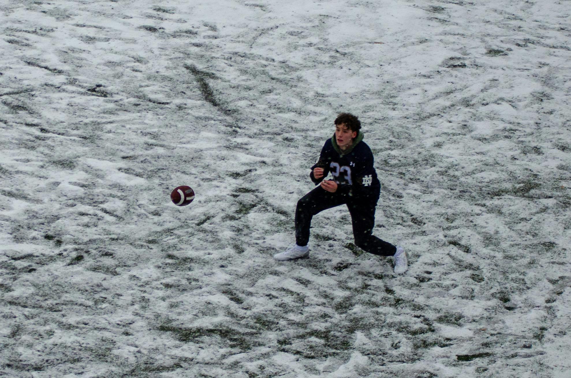 A student catches a football in a casual game on the band practice field at 326 Sumter St., Columbia, South Carolina, on Jan. 31, 2026. Hundreds of students spent the day outside despite the cold weather.
