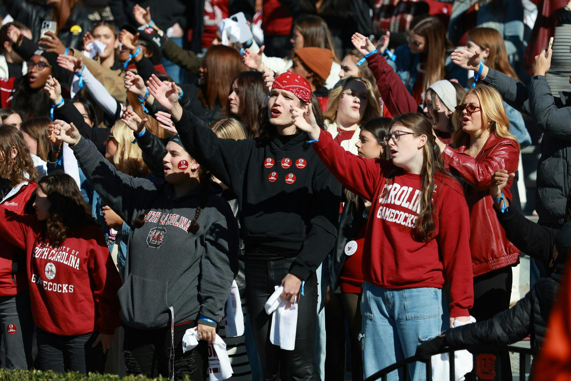 USC students cup their hands during the singing of the Alma Mater before the Gamecocks’ matchup against Clemson on Nov. 29, 2025, at Williams-Brice Stadium. Fans raise their hands as if making a toast during the line “Here’s a health, Carolina,” a long-standing game day tradition.