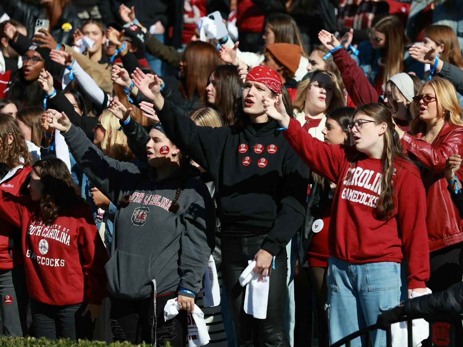 USC students cup their hands during the singing of the Alma Mater before the Gamecocks’ matchup against Clemson on Nov. 29, 2025, at Williams-Brice Stadium. Fans raise their hands as if making a toast during the line “Here’s a health, Carolina,” a long-standing game day tradition.