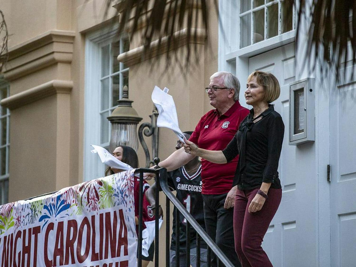 USC President Michael Amiridis (left) and his wife Ero Aggelopoulou-Amiridis (right) throw up their ralley towels during the playing of "Sandstorm" at the First Night Carolina event on Aug. 23, 2023. President Amiridis and head football coach Shane Beamer gave speeches during the event.