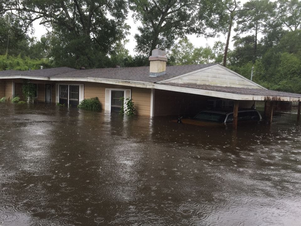 Kyle Parry, a Lumberton, Texas, firefighter, lost his home to flooding after Hurricane Harvey. The only thing he was able to save was his fiancee's wedding dress. (Family courtesy/TNS)
