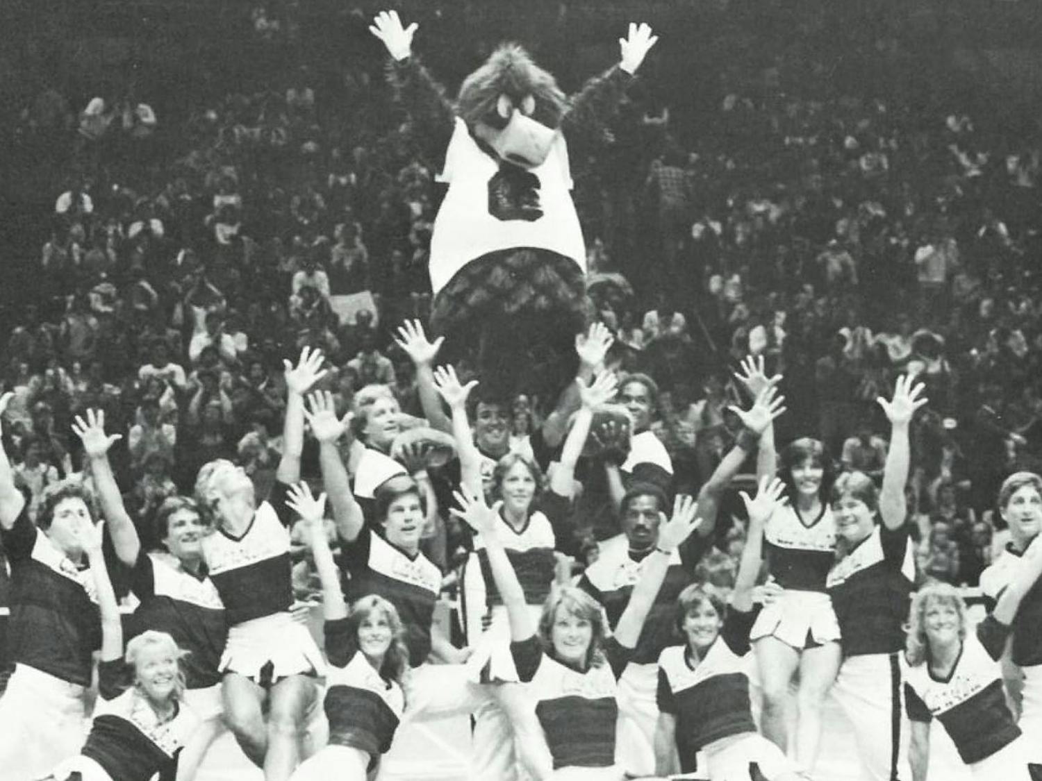 Cocky on the top of a cheer pyramid in 1982. John Routh, the man in the suit at the time, went on to become a mascot at the University of Miami. &nbsp;