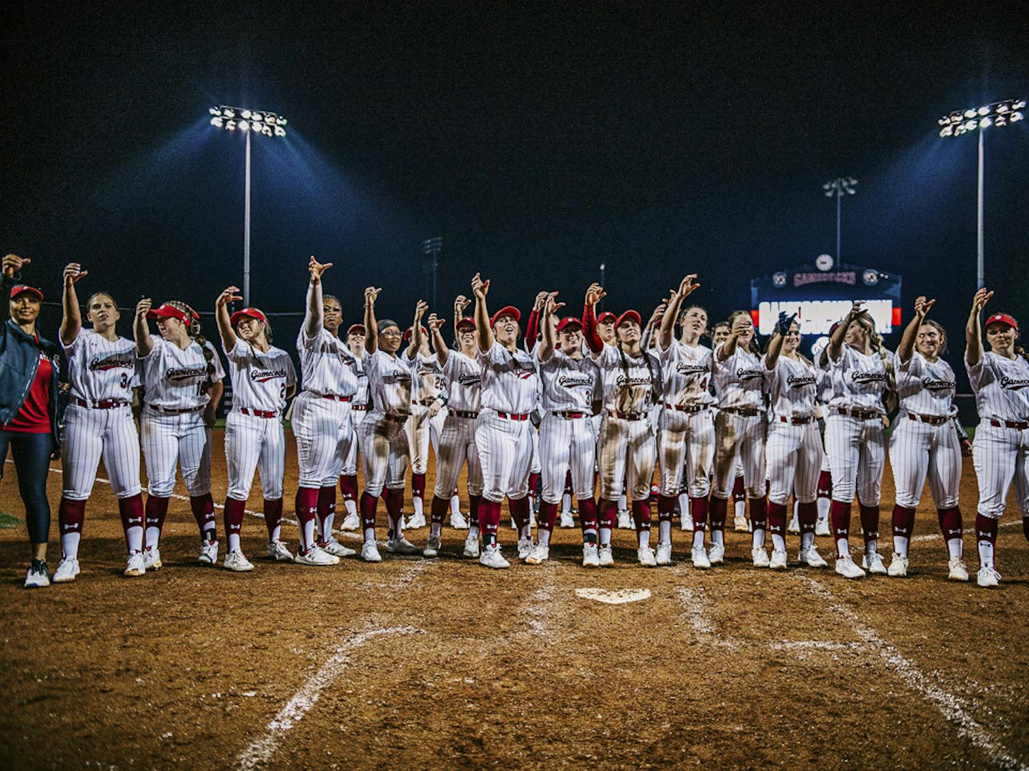 The Gamecock softball team offers a toast to the crowd after winning their home opener against the College of Charleston at Carolina Softball Stadium at Beckham Field on February 15, 2023. The Gamecocks beat the Cougars 8-0.&nbsp;
