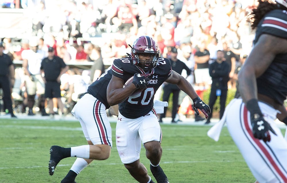 <p>Junior running back No. 20 Kevin Harris rushes the ball past Vanderbilt defense to gain yards and advance the Gamecocks to the endzone in the game versus Vanderbilt Oct. 16, 2021.</p>