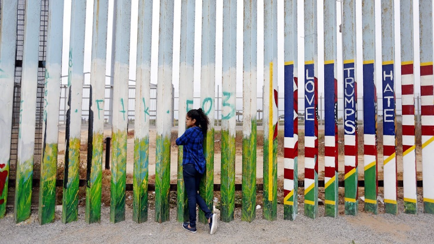 Jade Vega, 14, of Peru, peers through the fence at Friendship Park at the beach along the U.S.-Mexico border in Tijuana, Baja Calif., on July 29, 2017. Vega, who says she is a U.S. citizen, was visiting her mother in Tijuana for the summer. (Gary Coronado/Los Angeles Times/TNS)