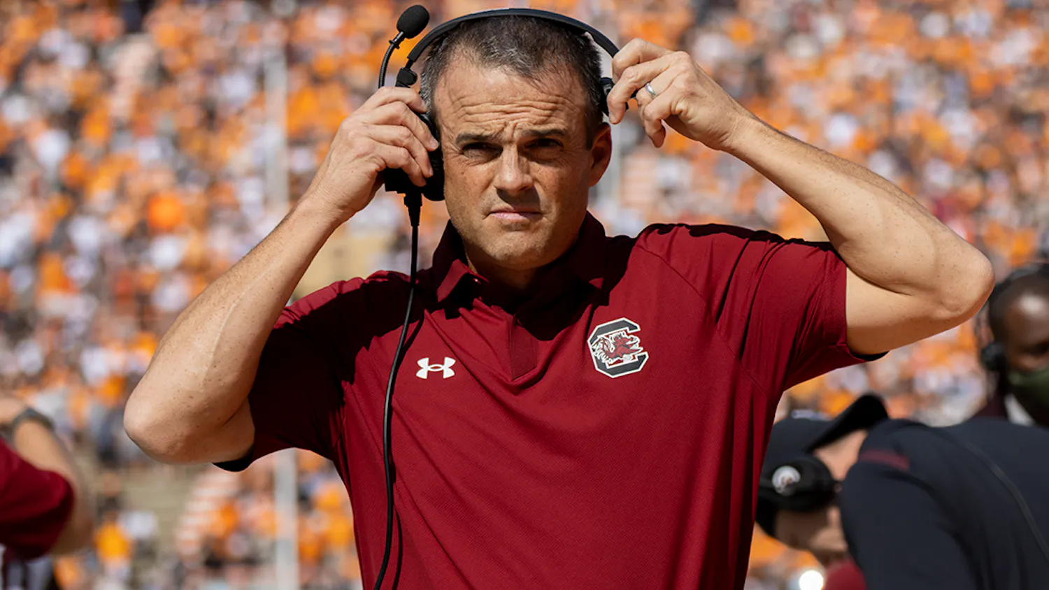 FILE - South Carolina head football coach Shane Beamer puts on his headset while facing off against Tennessee at Neyland Stadium on Oct. 9, 2021. 
