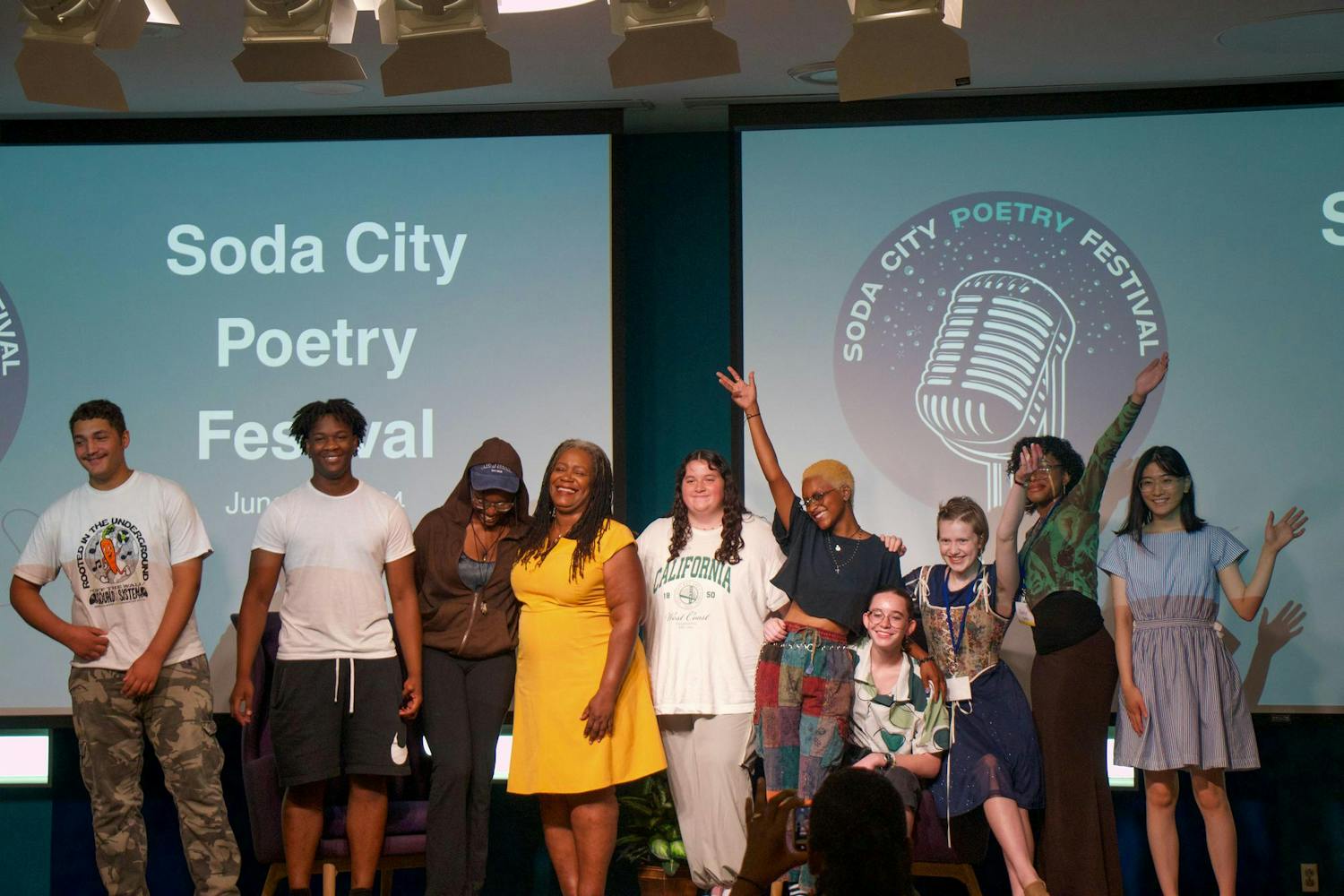 Participants of the teen poetry showcase at the inaugural Soda City Poetry Festival gather on stage for a group photo on June 22, 2024. Participants shared original works with an audience of their family members, peers, and festival attendees.