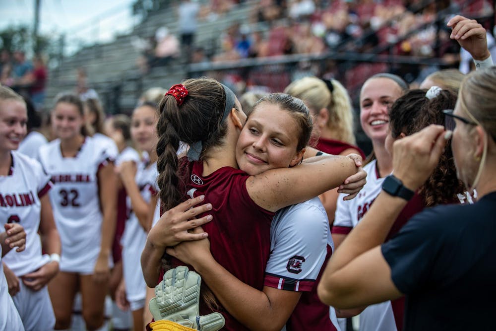 <p>Fifth-year goalkeeper Heather Hinz hugs senior midfielder Rylee Forster before their game on Sept. 10, 2023. The team celebrated senior night with a 2-0 victory over Furman.</p>