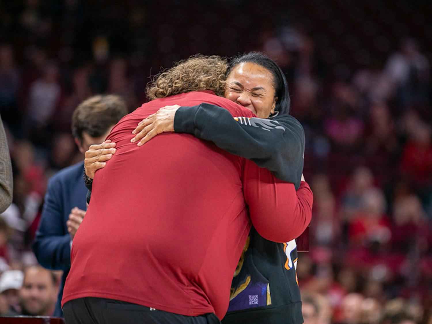 Head coach Dawn Staley embraces athletic trainer Craig Oates while giving him his championship ring. South Carolina played East Tennessee State on Nov. 7, 2022. The Gamecocks beat the Buccaneers 101- 31.