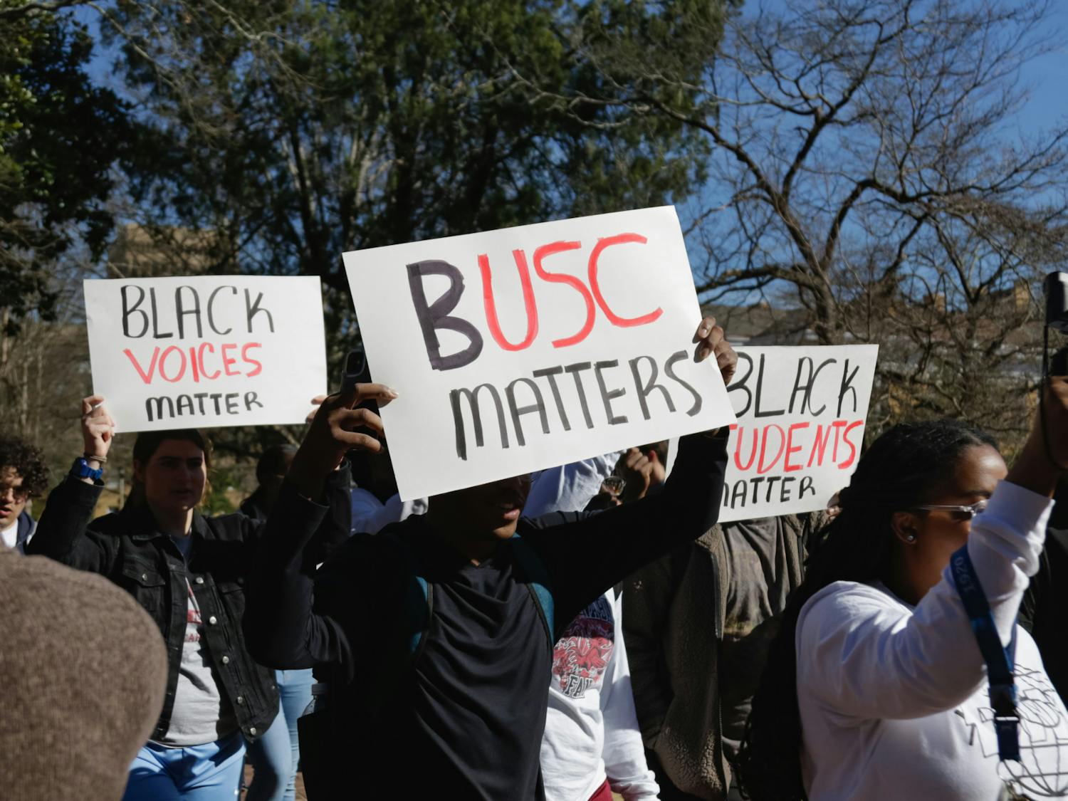 Protestors hold up signs while walking to Greene Street from the Horseshoe, advocating for Black students at the University of South Carolina on Jan. 20, 2023. The protest was organized by Courtney McClain, a fourth-year broadcast journalism student and the president of the SC NAACP Y&amp;C Division.