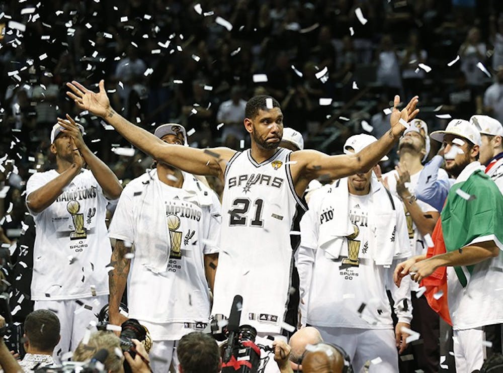 The San Antonio Spurs celebrate with the NBA Championship Larry O&apos;Brien trophy after defeating the Miami Heat, 104-87, in Game 5 of the NBA Finals at the AT&amp;T Center in San Antonio, Texas, on Sunday, June 15, 2014. (Al Diaz/Miami Herald/MCT)