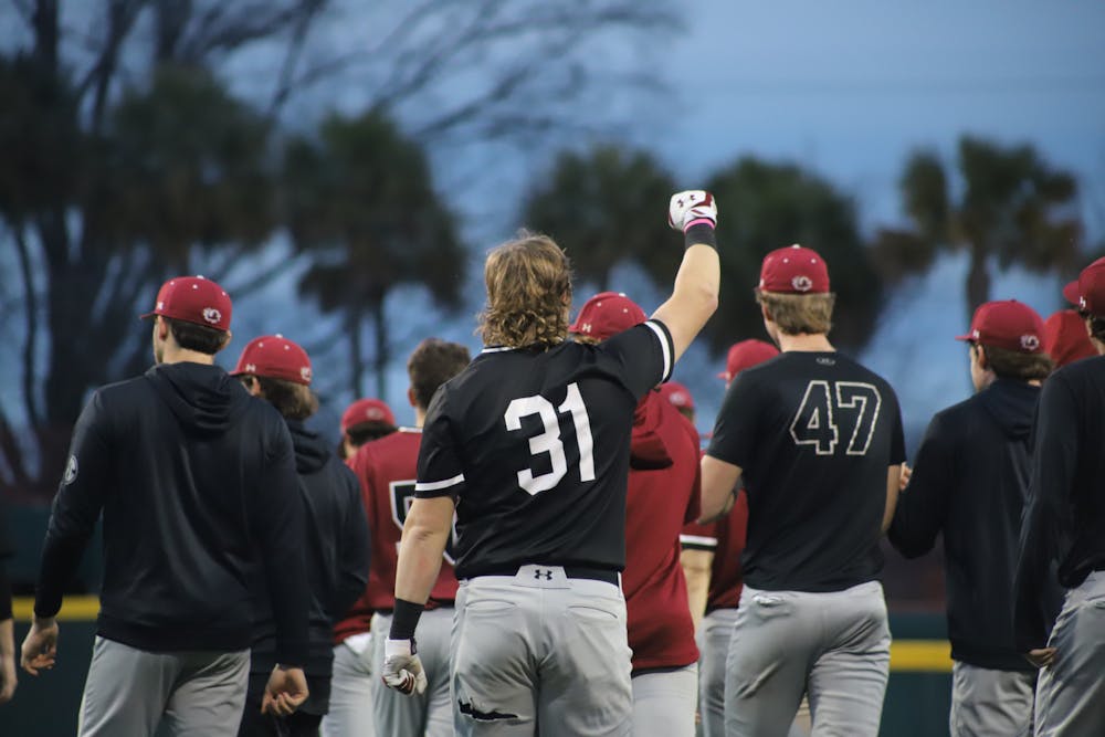 <p>FILE—The Gamecock baseball team celebrates the end of its first February scrimmage. The Garnet and Black scrimmage was held on Feb. 1, 2023, at Founders Park, where the Garnet team beat the Black team 4-2.</p>