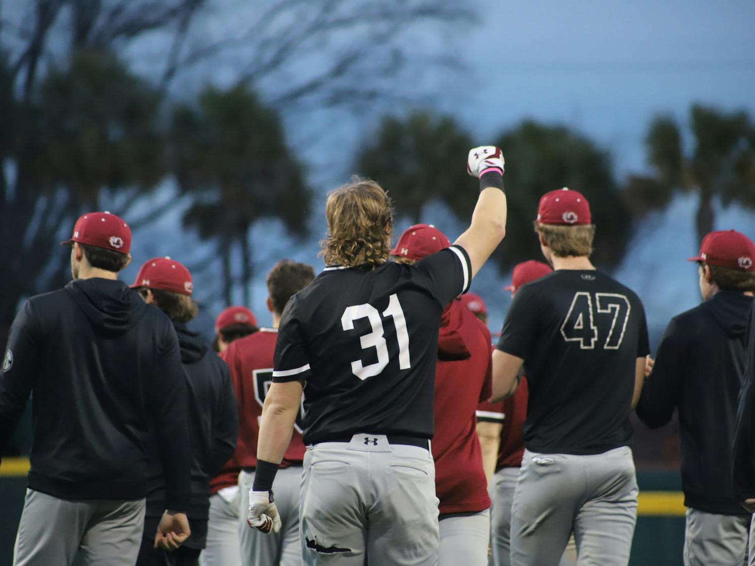 FILE—The Gamecock baseball team celebrates the end of its first February scrimmage. The Garnet and Black scrimmage was held on Feb. 1, 2023, at Founders Park, where the Garnet team beat the Black team 4-2.