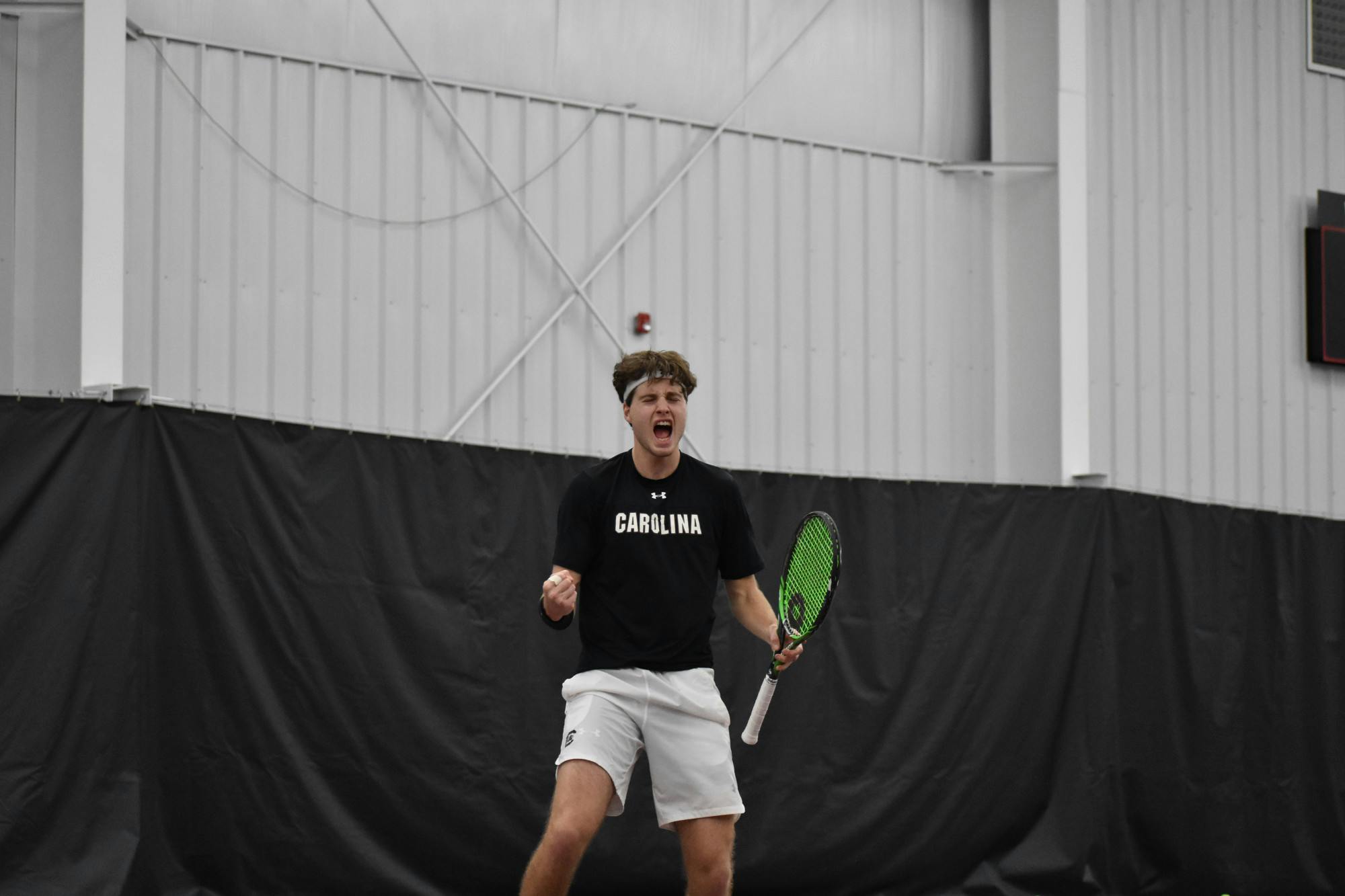 Junior Toby Samuel yells out in celebration after winning his singles game on day two of the ITA Kickoff Weekend event at the Carolina Indoor Tennis Center on Jan. 29, 2023. The South Carolina Gamecocks beat N.C. State 4-0, making it the winner of the ITA tournament.&nbsp;