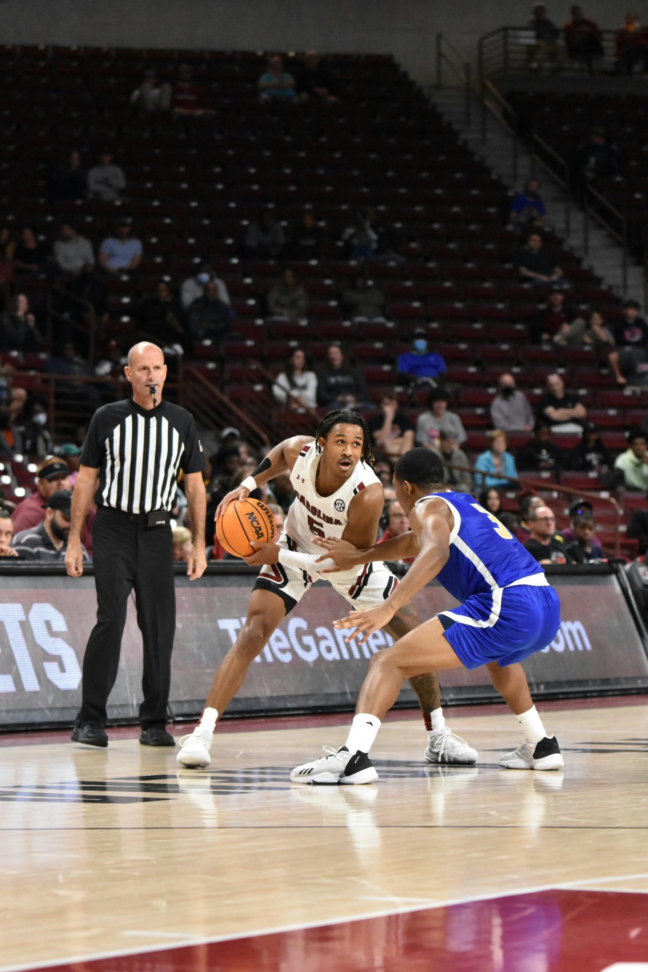 Junior guard Meechie Johnson keeps the ball away from the lions at the basketball team's scrimmage on Nov. 2, 2022. His dominating performance on the court helped lead the Gamecocks to an 80-41 win against Mars Hill. 