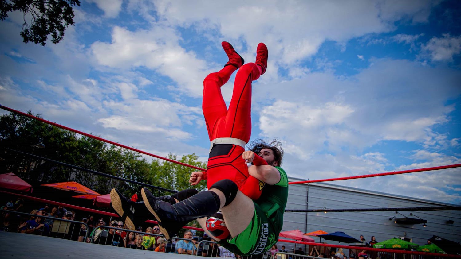Dennis Parker (green) pile drives Wrestle Ranger (red) during the Pro Wrestling TURBO on Aug. 24, 2025 at The Mill in Greenville, South Carolina. Based in South Carolina, the Pro Wrestling TURBO league brings together new and veteran wrestlers.