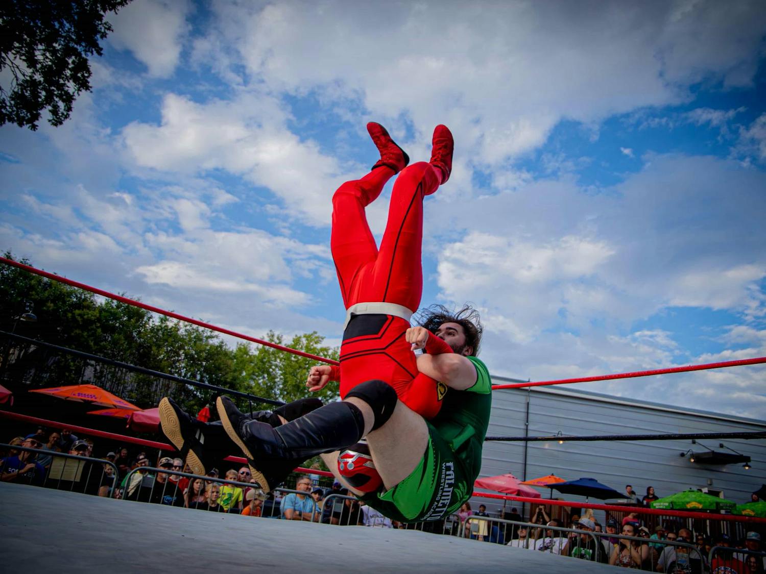 Dennis Parker (green) pile drives Wrestle Ranger (red) during the Pro Wrestling TURBO on Aug. 24, 2025 at The Mill in Greenville, South Carolina. Based in South Carolina, the Pro Wrestling TURBO league brings together new and veteran wrestlers.