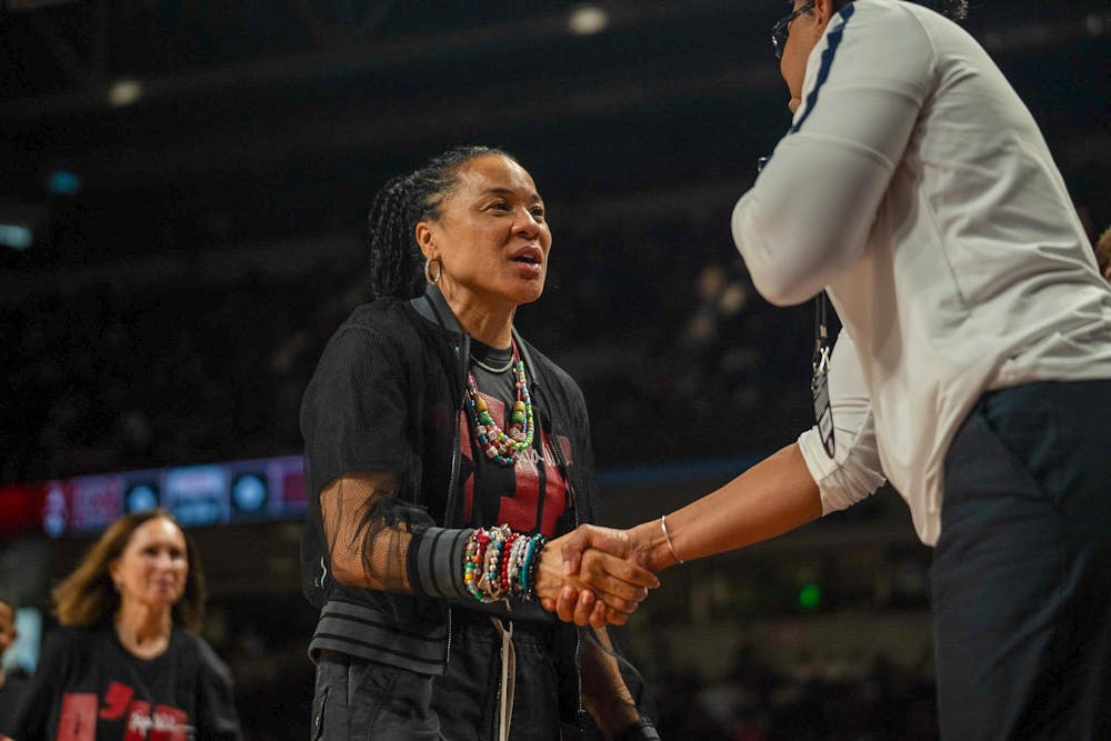 <p>FILE — Women's basketball head coach Dawn Staley shakes hands with Auburn's coaches before South Carolina's game on Feb. 2, 2025, at Colonial Life Arena. Staley has been coaching at South Carolina for 17 years as of November 2025.</p>
