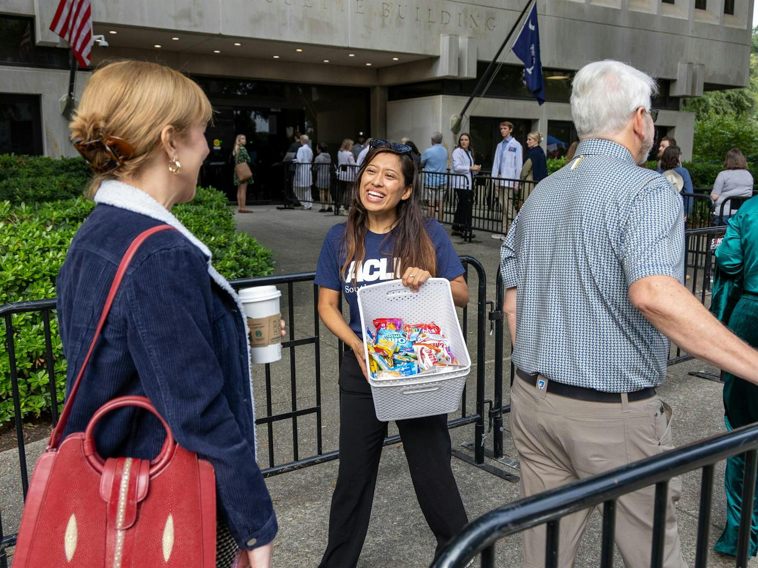 A volunteer with the American Civil Liberties Union hands out snacks to people waiting in line to speak at the public hearing for S.B. 323 at Gressette Building on Oct. 1, 2025. According to the ACLU, the bill would open the door to restrictions on in vitro fertilization by defining a “human embryo” as a fertilized egg or zygote