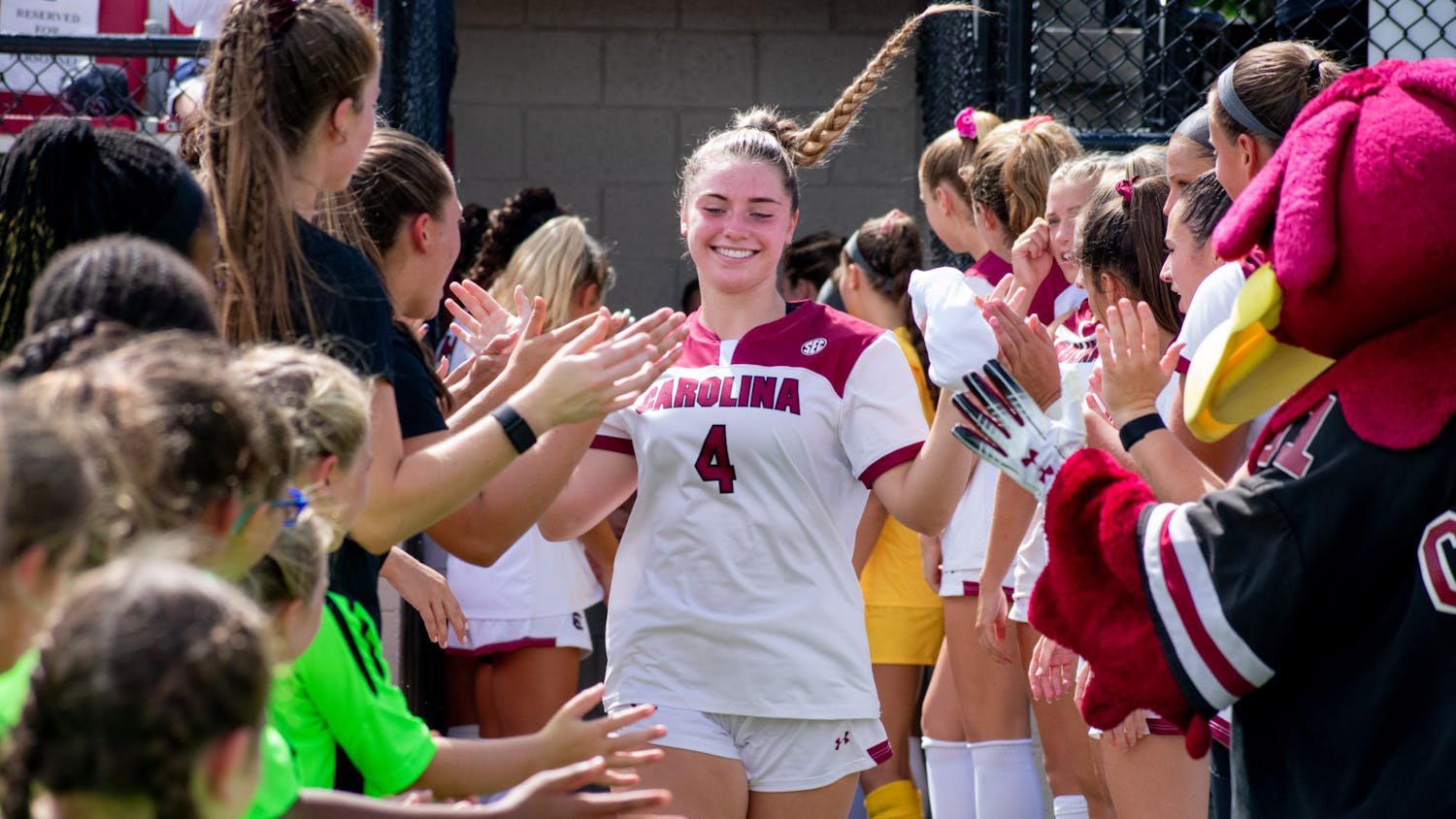 FILE— Freshman forward Shea 'O Burke high fives her teammates as she makes her way to the field in preparation of their game against NC on Sept 11, 2022.