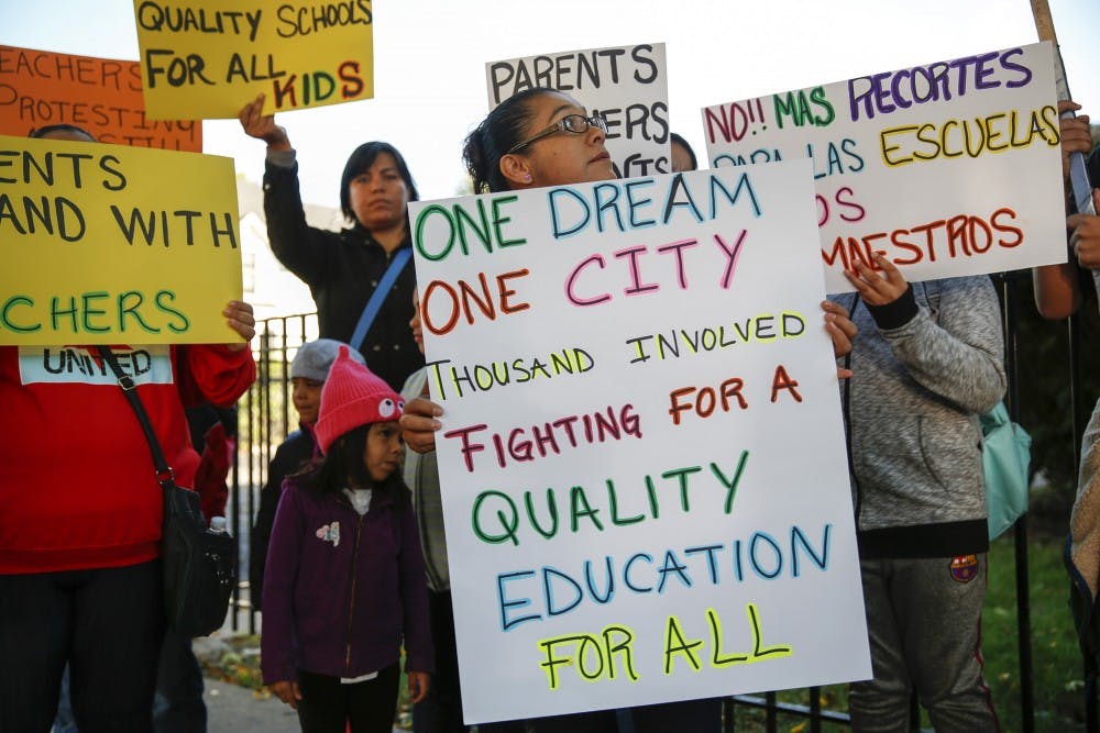 Parents, students and supporters of Chicago Public Schools teachers gather at a press conference held on Monday, Oct. 10, 2016 in Chicago's Ravenswood neighborhood, near Mayor Rahm Emanuel's home. Parents and students from multiple schools who support the teachers rallied and then canvassed the area, pushing for new school funding. (Jose M. Osorio/Chicago Tribune/TNS)