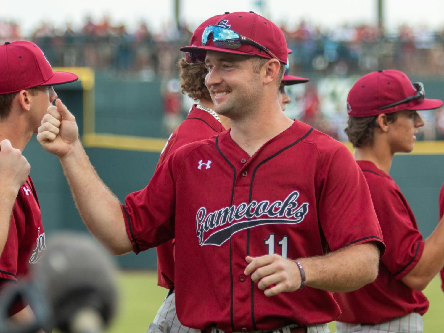 FILE—Fifth-year outfielder Andrew Eyster fist bumps his teammates before a game against Clemson on March 5, 2022, in Columbia, SC. The Gamecocks lost the three-game series to the Tigers, 0-3.
