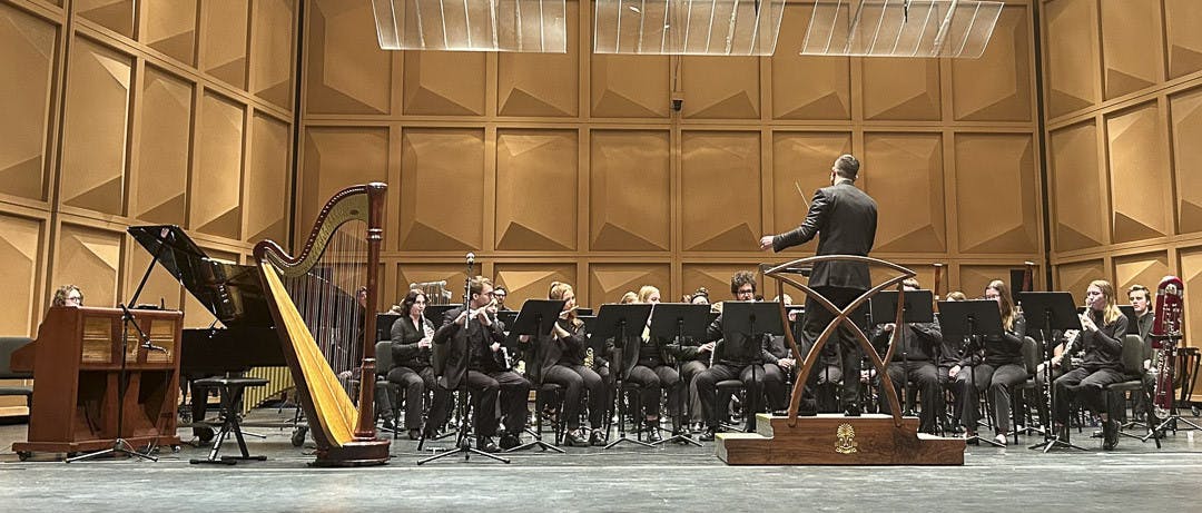 Fourth-year music student Deshawn Stevents (left) and first-year graduate music performance student Alyssa Santivanez (right) narrate quotes from Martin Luther King, Jr. during the USC wind ensemble's performance of Joseph Schwantner and Nikk Pilato's piece "New Morning for the World" at the Kroger Center on Feb. 10, 2023. The wind ensemble is currently on tour in Georgia, with its final show at the University of Georgia on Feb. 15, 2023.&nbsp;