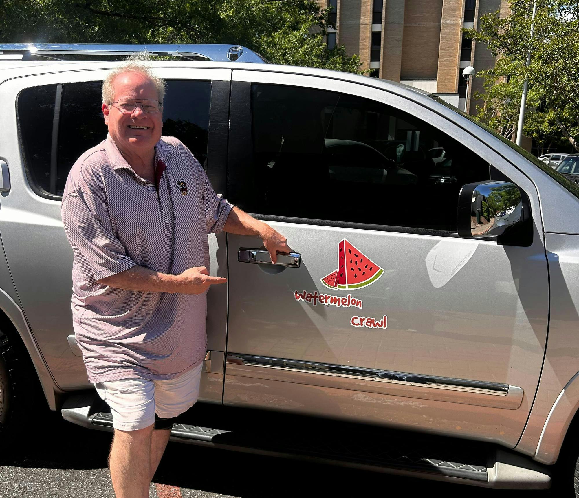 Columbia resident Mike Sloan poses with his car, the "Watermelon Crawl.” Sloan promotes rideshare safety at USC.
