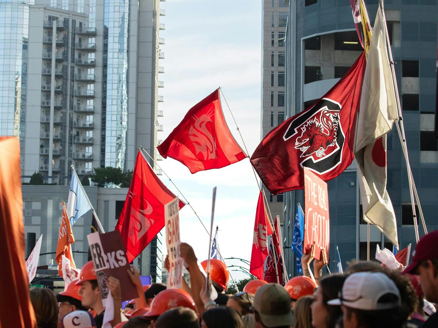 Fans gathered at Romare Bearden Park wave flags and hoist signs hoping to get on camera. The crowds gathered for College GameDay as early as 3 a.m. on Sept. 2, 2023.
