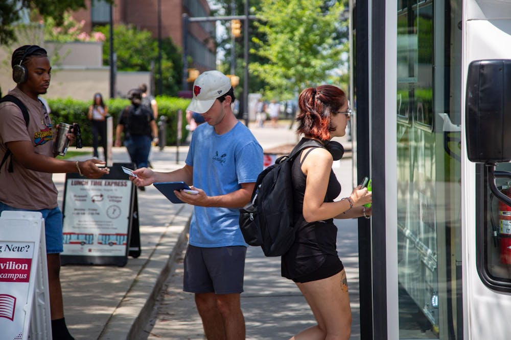 <p>Students walking to board the lunch shuttle heading to Campus Village on Aug. 26, 2024. Campus Village, which opened in the 2023-2024 school year at the University of South Carolina, is the newest dorm on the west side of campus.</p>