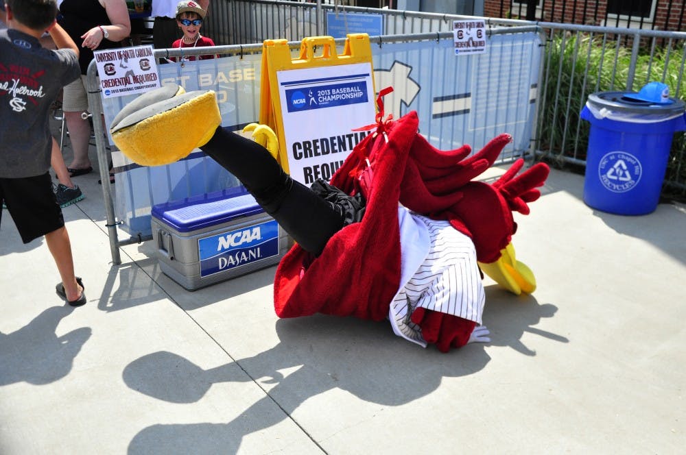 Cocky does the worm in a dance off with a young fan.