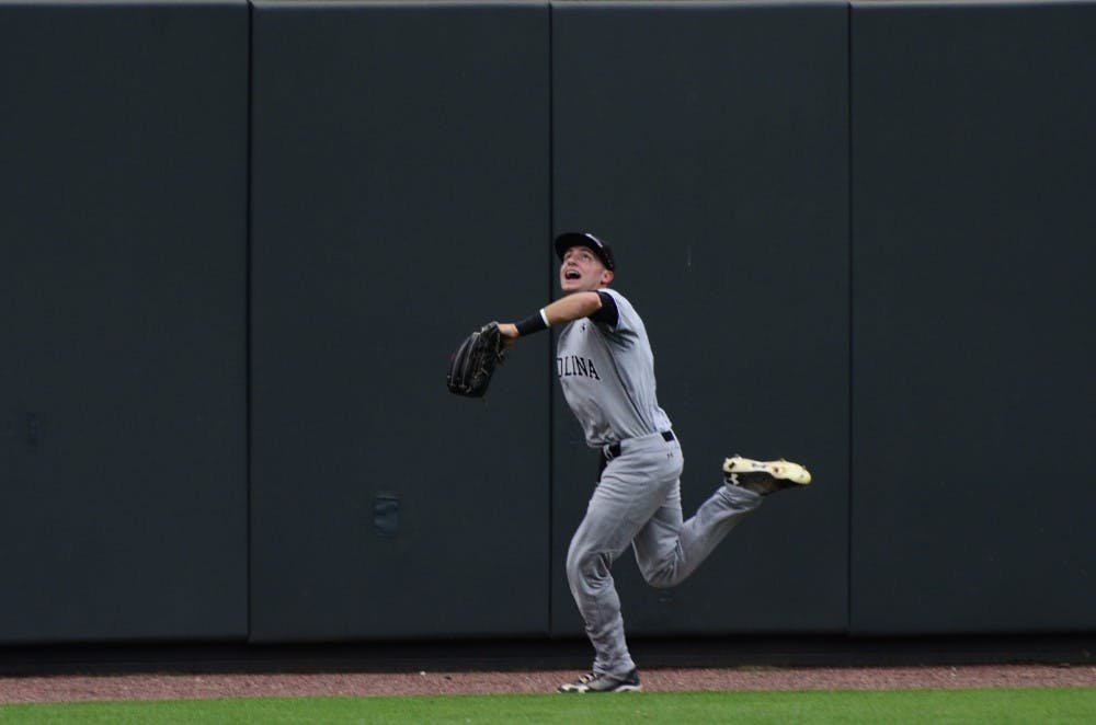 Graham Saiko runs after a fly ball.