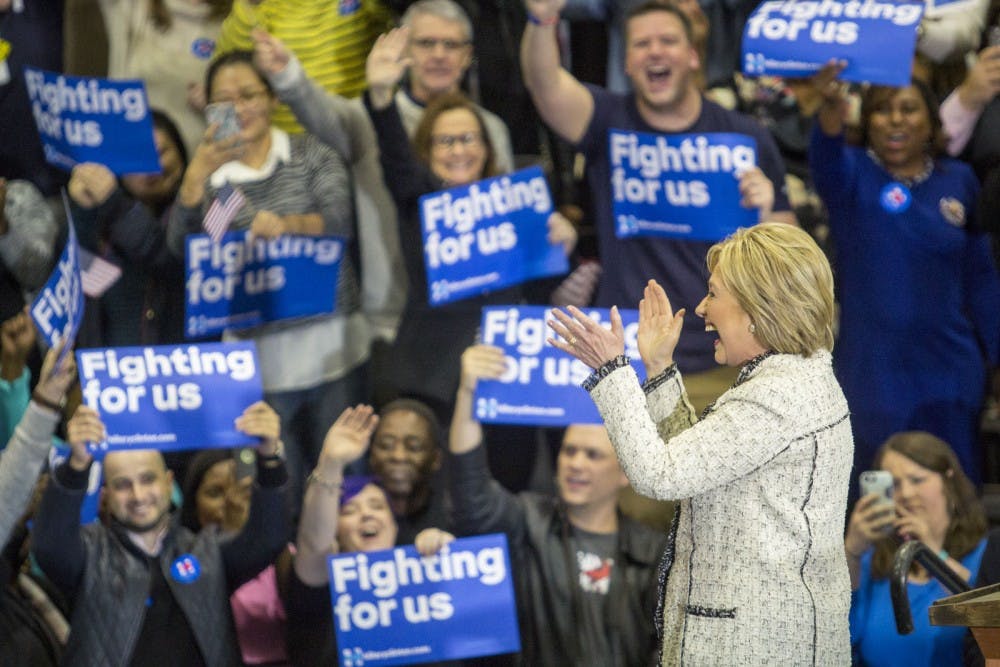 Hillary Clinton claps along to the current song playing on the playlist her team put together as the crowd cheers. The playlist included power hit songs from Kelly Clarkson, Katy Perry, and Taylor Swift. Hillary's campaign hosted a watch party at the USC Volleyball Center on the night of the South Carolina Democratic Primaries, February 27, 2016. Within minutes of the polls closing, it was announced that Hillary had taken South Carolina. Steve Benjamin, mayor of Columbia, was present at the watch party and talked with fellow Hillary supporters as they waited for Hillary to make her victory speech. Senator Jim Clyburn stepped up to speak first after the announced win and then welcomed Hillary to the stage where she gave a motivational speech to her supporters and said, "tomorrow this campaign is going national!"