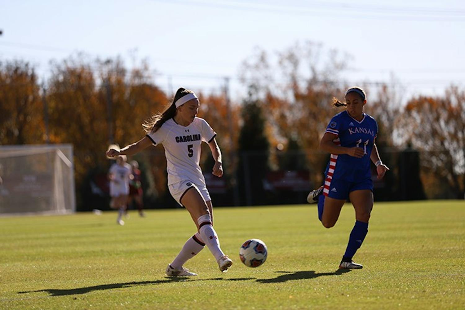 Senior forward Luciana Zullo dribbles the ball as a Kansas player runs beside her. Zullo tied in 9th place for NCAA Tournament points in a career with four.
