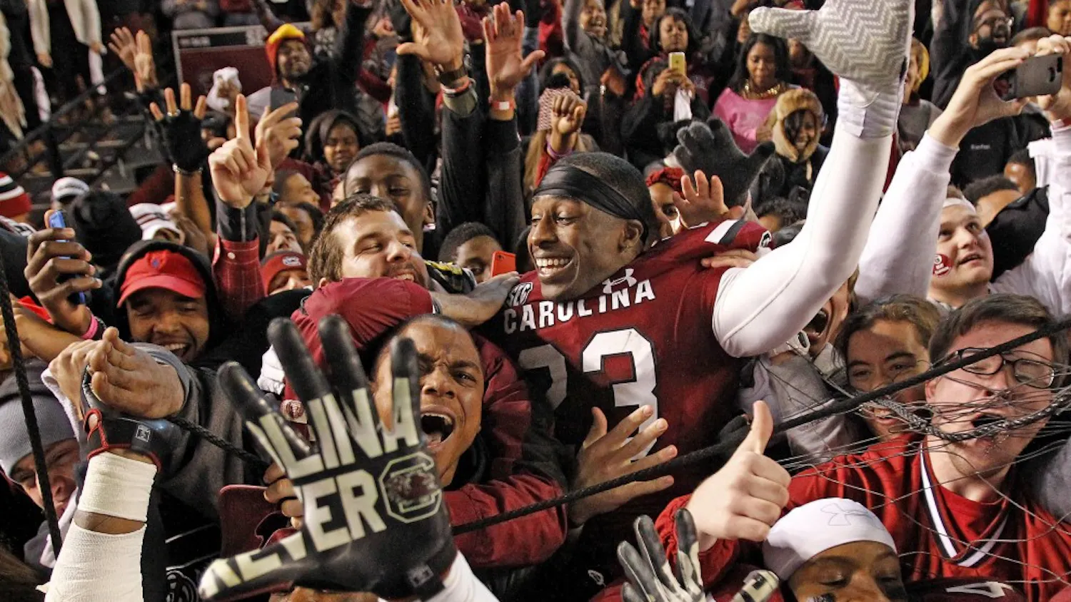 South Carolina players celebrate with fans after a 31-17 win win against Clemson at Williams-Brice Stadium in Columbia, S.C., on Saturday, Nov. 30, 2013. (Gerry Melendez/The State/MCT)