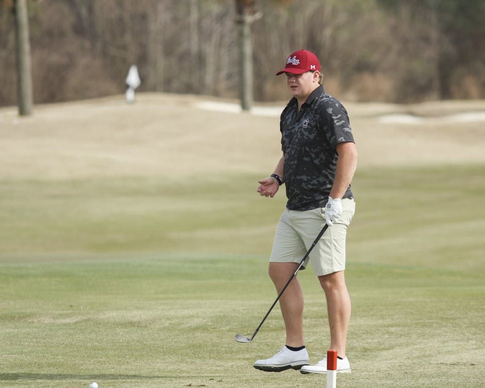 Fifth-year golfer Evans Lewis watches after he putts the ball during practice on Feb. 8, 2023. After placing highest individually at the Norman Regionals in Oklahoma last season, Lewis was the only member of the Gamecocks to make it to the national championship.