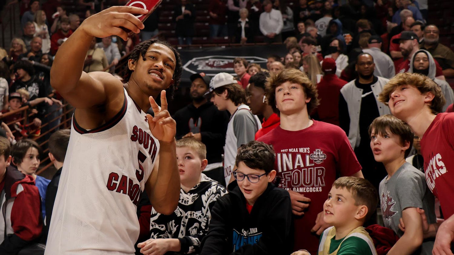 Junior guard Meechie Johnson takes pictures with fans after the Gamecock's 75-60 victory over Vanderbilt on Feb. 10. The Gamecocks are now 21-3 overall and 9-2 in SEC play.